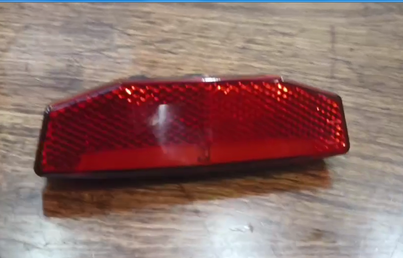 Rear tail light for LANKELEISI MG740PLUS e-bike, mounted on the bikeโs rear, with clear lens and LED illumination.
